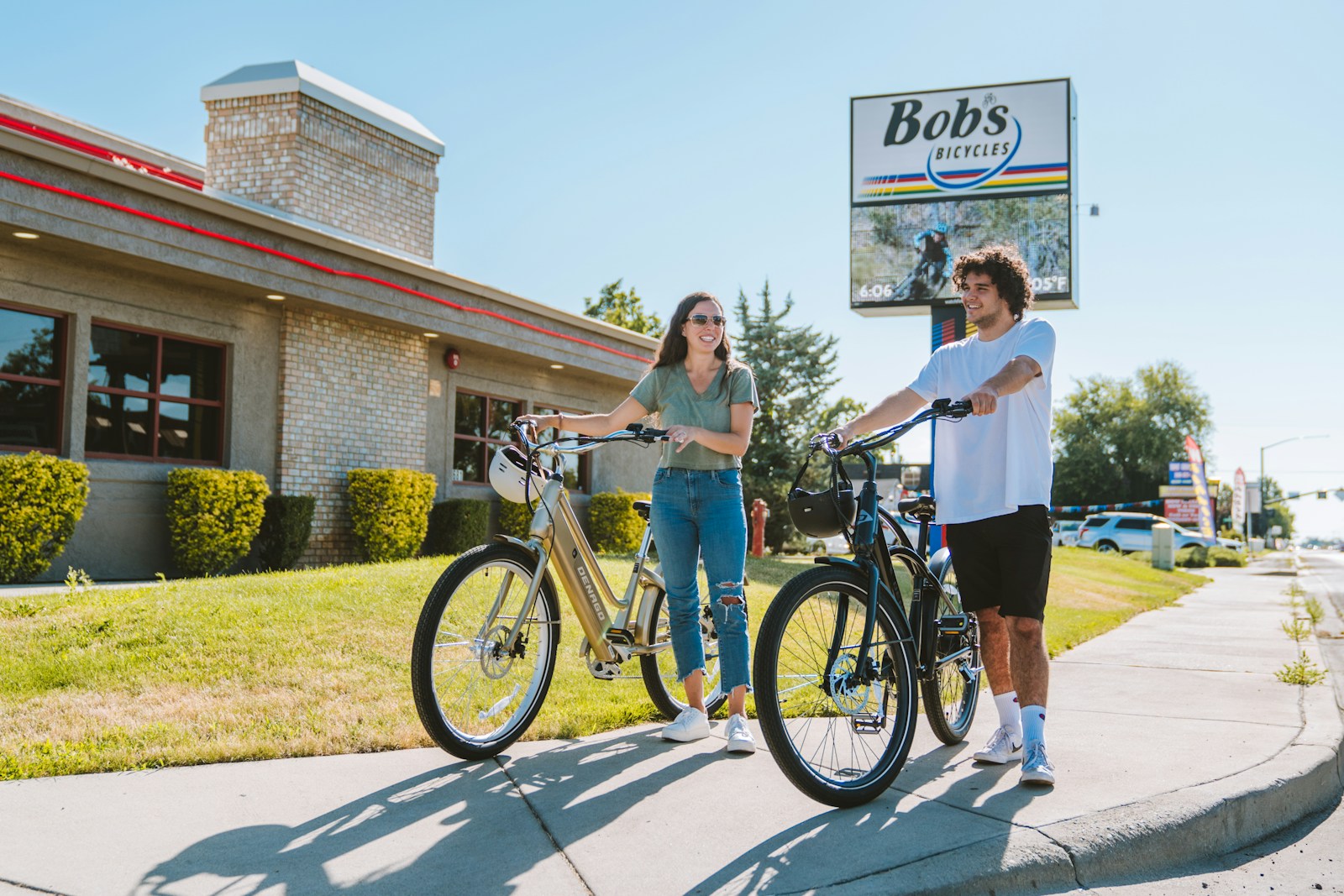 a man standing next to a woman on a bike